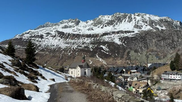 Mountain village of Andermatt in Switzerland, Alps and Swiss landscape, church of Chapel Maria Hilf