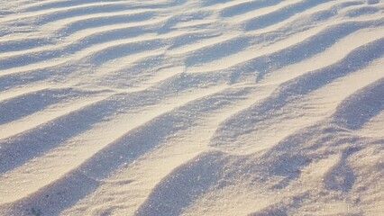 Close-up shot of snow-covered ground with fresh tracks and frost