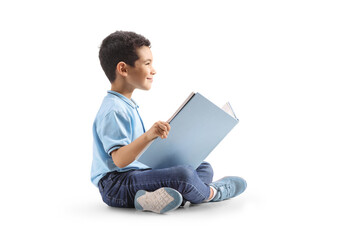 Boy sitting on floor and reading book