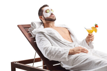 Guy in a bathrobe enjoying at the spa with a cocktail