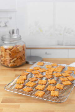 Homemade Cheese Crackers on Cooling Rack on Butcher Block Kitchen Countertop