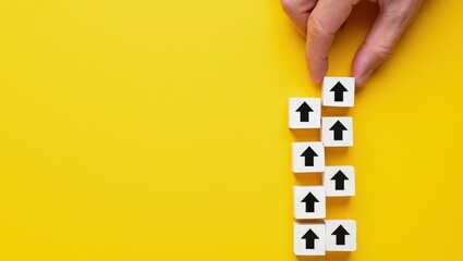 Hand making a row of arrows on a yellow background. Space for text. Paving the way, making plans. Next steps and vision. Course to go forward.