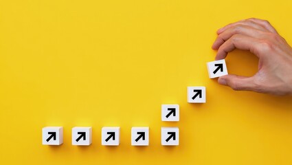 Hand making a row of arrows on a yellow background. Space for text. Paving the way, making plans. Next steps and vision. Course to go forward.