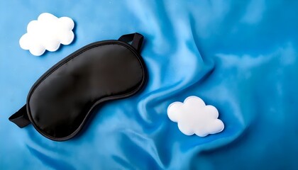 Obraz premium a silk black sleep mask with white clouds on the pastel blue background, large space for copy