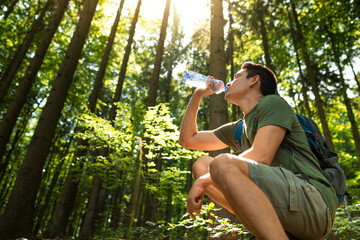 Man drinking water outdoors 