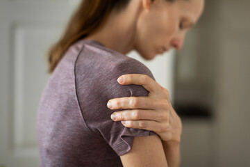 woman with pain in shoulder joint
