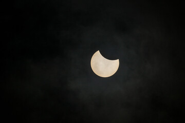 Solar eclipse moon shadow crossing bright sun disk.