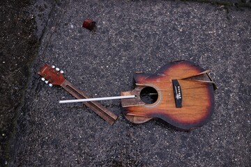 Broken guitar in snowy rain