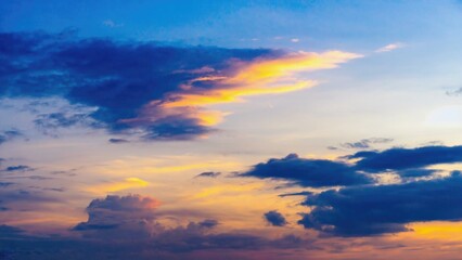 A plane soars through the sky at sunset, with warm hues and clouds in the background