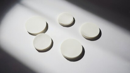 Group of four white buttons on a table, ready for use or display