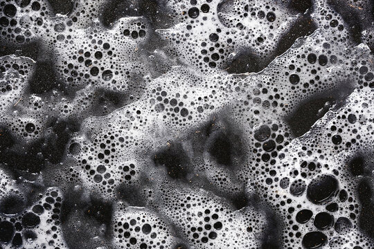White foam bubbles texture. Soap water background. Clean foam abstract. Fresh soapy surface. Washing bubble layer. Cleaning bubbles closeup. Shiny wet foam surface. Hygiene cleaning pattern.