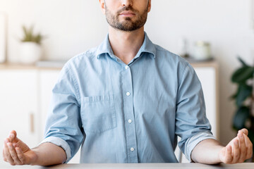 Naklejka premium Office Zen. Relaxed Male Entrepreneur Meditating At Workplace, Coping With Stress At Work, Sitting At Desk With Eyes Closed, Free Space