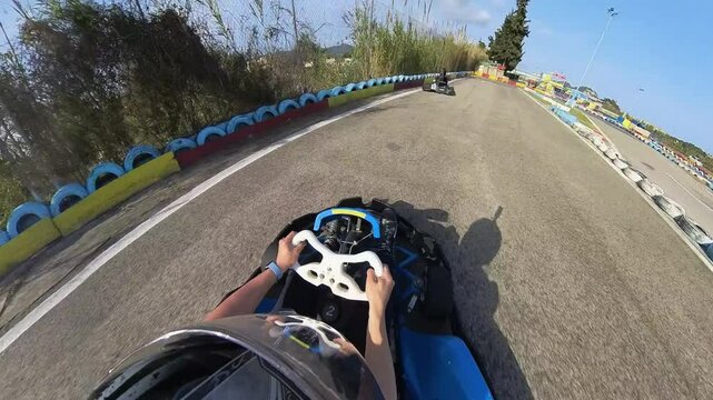Fun race with tiny cars karting on a tarmac circuit helmet point of view with overtakes and crashes on a racing sports event