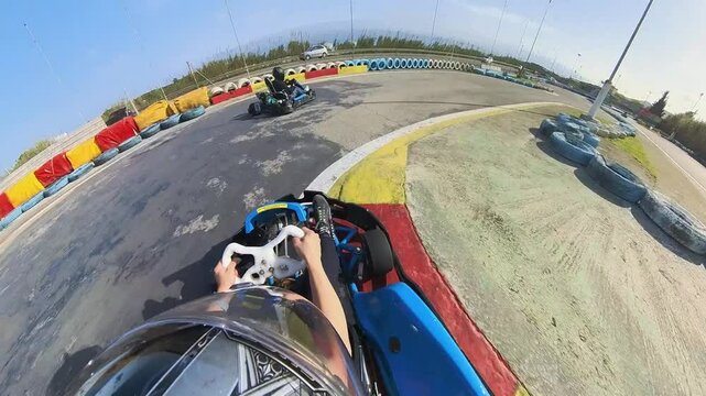 Fun race with tiny cars karting on a tarmac circuit helmet point of view with overtakes and crashes on a racing sports event
