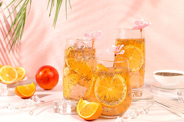 Modern still life with citrus fruits. Diet vegan cocktail with chia seeds, orange, lime, violet and...