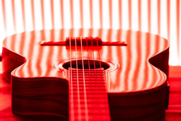 Guitar, beautiful guitar wrapped in lines of lights, selective focus.