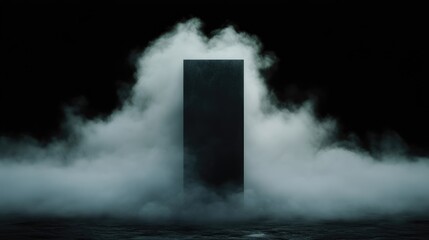 Mysterious, dark rectangular obelisk shrouded in fog