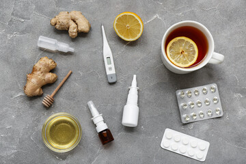 Nasal drops with lemon tea, ginger, honey and pills on grunge background