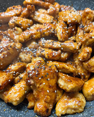 Enjoying Deliciously Glazed Chicken Wings Made in a Pan for a Tasty Meal or Snack