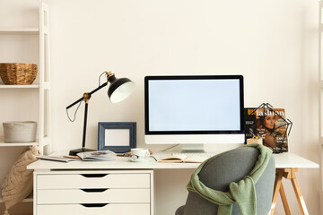 Interior of modern office with stylish workplace, lamp and chair