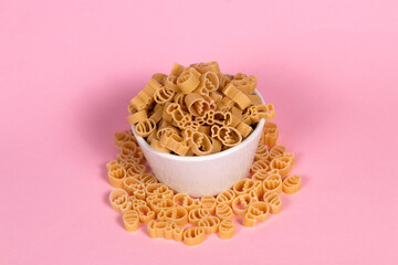 Easter pasta in a white bowl on a pink background