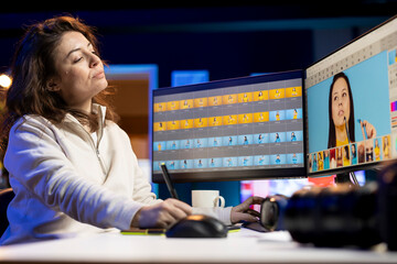 Photographer using photo editing software on PC display in multimedia creative studio, making...