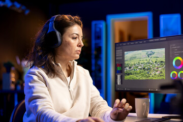 Video editor analyzing film montage before editing color balance and lighting in creative office....