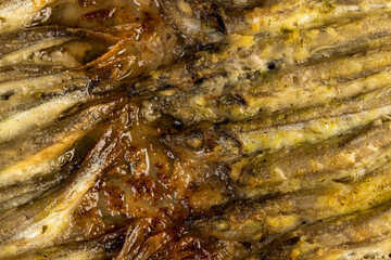 stacked in rows cooked hot capelin baked in sunflower oil