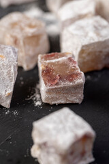 Turkish delight with cherry closeup, Turkish delight with the addition of dried red berries in powdered sugar close up