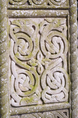 The stone carving has a Celtic design with a lot of detail