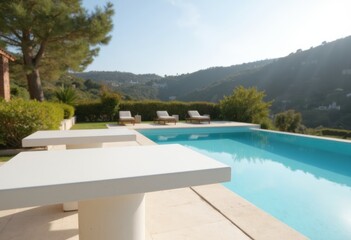 Modern outdoor pool area with lounge chairs and scenic mountain views