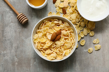 Bowl with cornflakes on grunge background, closeup