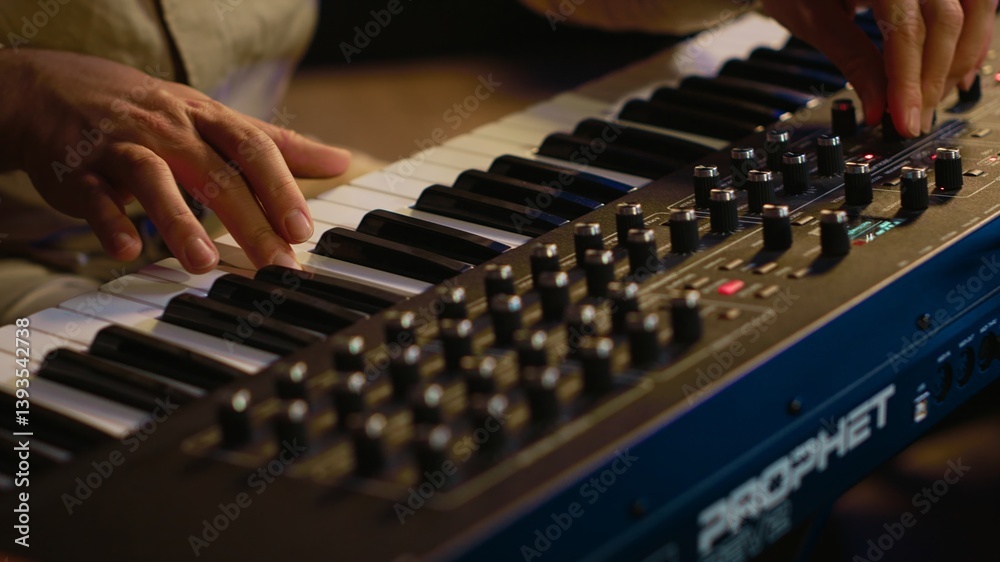 Poster Skilled musician performing in control room at studio and recording tracks for new album, working with audio console and flying faders. Songwriter composing new music on technical tools. Camera A.