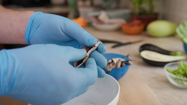 Chef Is Cleaning Italian Fish Sardines In A Restaurant Luxury Kitchen