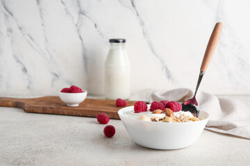Bowl with cornflakes, yogurt and berries on marble background