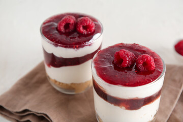 Glasses with delicious berry cheesecake on white background, closeup
