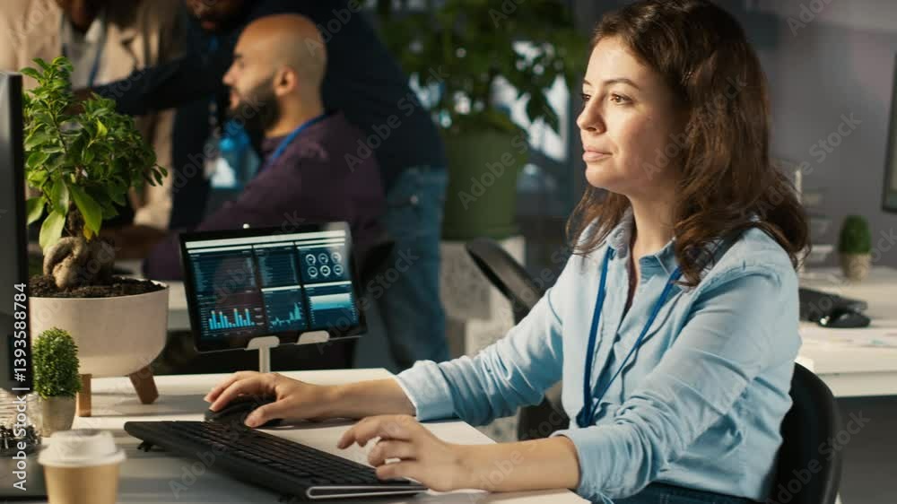 Poster employee at office desk typing on keyboard, editing documents on computer. worker inputting data on 