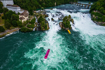 Aerial view of famous Rheinfall and colorful touristic boats in Switzerland