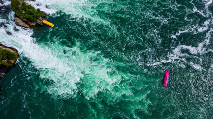Aerial view of famous Rheinfall and colorful touristic boats in Switzerland