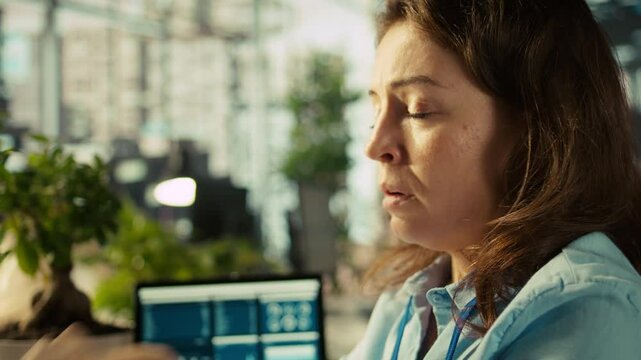Stressed employee at office desk feeling tired while editing documents on computer. Overworked woman exhausted after inputting data in workplace at PC all day, feeling fatigue, camera B