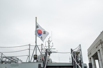 national flag of south korea on the military ship displayed at open-air exhibition hall in war memorial museum of south korea
