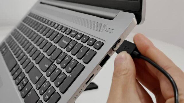 slowly Connecting USB into laptop,mouse usb plug into laptop.USB cable connected on USB port of a laptop,slow motion
