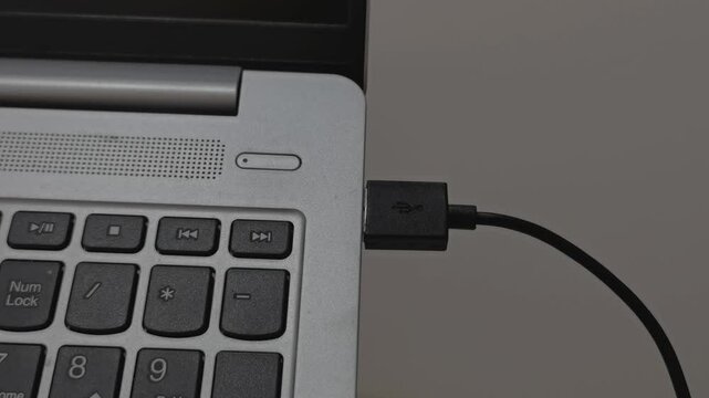 Connecting USB into laptop,mouse usb plug into laptop.USB cable connected on USB port of a laptop