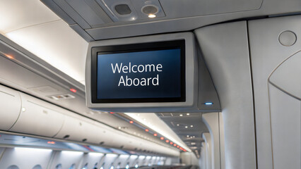 Digital display welcoming passengers aboard an airplane interior  
