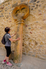 Woman discovering the biggest key made of stone