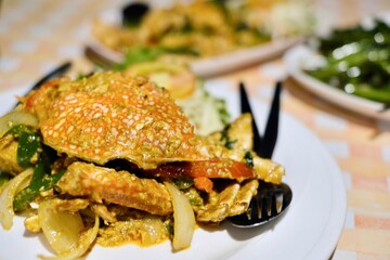 Thai dishes of stir-fried yellow curry crab and morning glory (Kang Kong) on a table with gingham tablecloth at Cliff Restaurant, Patok Bay - Ko Racha Yai, Thailand