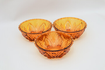 Amber Tinted Glass Bowls with Intricate Leaf and Geometric Designs Arrangement
