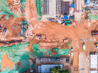 Aerial top view of the construction site at the initial stage of construction and heavy...