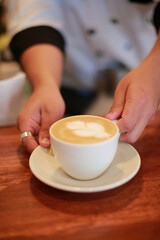 Barista delivers freshly brewed coffee to the customer