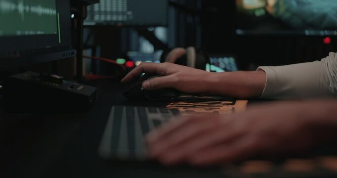 Film editor&rsquo;s Hands typing on a keyboard and mouse